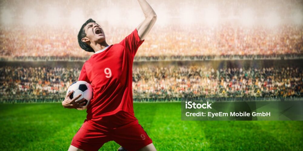 Soccer Player Celebrating In Stadium